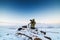 Man with photo camera on tripod taking timelapse photos in the arctic tundra.