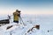 Man with photo camera on tripod taking timelapse photos in the arctic tundra.