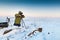 Man with photo camera on tripod taking timelapse photos in the arctic tundra.