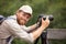 man photographer with backpack and camera taking photo