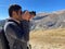 Man photographer holding a camera taking scenic pictures