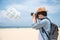 Man photographer take photo of parasailing on the beach