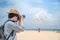 Man photographer take photo of parasailing on the beach