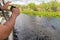 Man photographing close alligator from airboat in Everglades national park, Florida, United States of America
