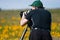 Man Photographing in Field of Wildflowers