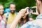 Man photographing friends by smartphone