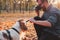 Man photographing his dog in the park.