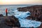 Man photographing rocky coast on Lanzarote island