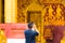 Man photographing temple Wat Sensoukaram in Louangphabang, Laos. Close-up.
