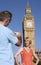 Man Photographing Woman Against Big Ben Tower