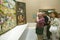 Man photographs The Garden of Earthly Delights by Hieronymus Bosch, in the Museum de Prado, Prado Museum, Madrid, Spain