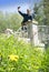 Man photographs himself on the river bank at the bridge on phone, a selfie takes