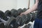 Man pick up dumbbell weight from rack in gym