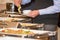 Man picking food from chafing dish heaters