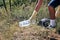 Man picking plastic in the woods.