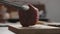 man picking ready to cook steak with tongs from oak board closeup