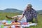 Man on Picnic Eating a Bun