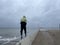 Man on a pier on a rainy day