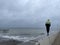 Man on a pier on a rainy day