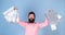 Man in pink shirt with happy face and long beard holding gift bags, birthday party, celebration concept. Hipster with