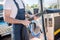 Man with pipe of vacuum cleaner at car wash