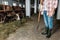 Man with pitchfork feeding cows