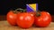 Man placing decorative toothpick with flag of Bosnia and Herzegovina into bunch of tomatoes.