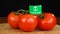 Man placing decorative toothpick with flag of Saudi Arabia into bunch of tomatoes.