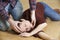 Man Placing Woman In Recovery Position After Accident