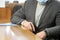 A man in a plaid jacket and protective medical mask sits at a table in a large conference room or auditorium. Entrepreneur, lawyer