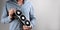 Man in plaid shirt holding grafic video card on gray background with copy space. Bitcoin cloud mining