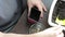 A man is planting seeds in a pot. Spatula pours soil into it. View from above.