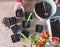 Man plants seeds in seedling containers with earth. Garden objects on the table top view