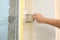 Man plastering window area with putty knife, closeup. Interior repair