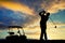 Man play golf at sunset