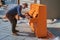 Man is playin a orange colored piano