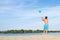 A man playing beach volleyball on hot sand on a sunny day.  Back view.  Sports  lifestyle