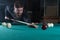 Man playing billiards. look at the ball.