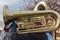 Man playing brass trumpet in band in outdoor event