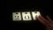 Man playing with cards with number on black table, light on number, vintage style, happy New Year, 2016