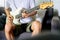 Man playing electrical guitar on sofa at home