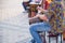 Man playing ethnic drum on street