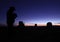 Man Playing Flute in Desert at Dusk