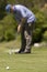 Man playing golf on a fresh green golf course