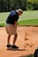 Man playing golf shot out of sand bunker on green