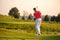 Man playing golf during sunny day