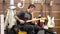 Man playing guitar inside electrical store on boxing day sale