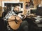 Man playing guitar in a recording studio. Concept guitarist composing music