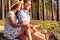 Man playing guitar to his girl on a picnic.