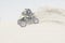 Man playing with his quad bike in the desert